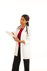 Smiling female medical doctor writing notes on clipboard on white backdrop