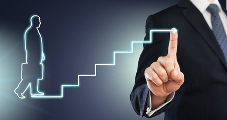 Businessman drawing graphics on background