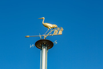 Brass Egret Weather Vane Against Bright Blue Sky