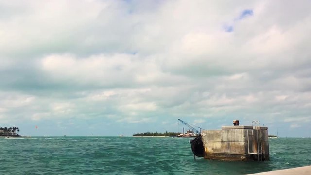 Time Lapse from Mallory Square Key West, Florida of boats passing on a cloudy day.