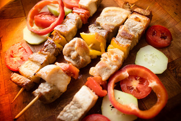 Grilled meat with vegetables. Barbecued shish kebab or shashlik on sticks
