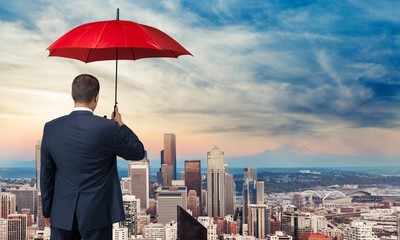 Fototapeta na wymiar Portrait of businessman with umbrella on background