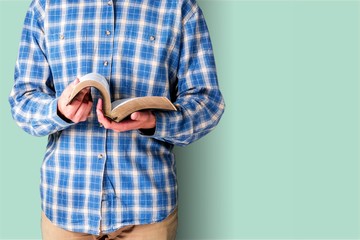 Man hand holding holy bible on background