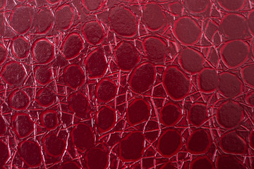 Red leather texture with irregular circular patterns