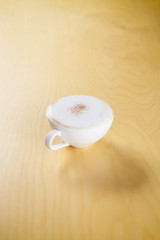 hot cappuccino on the wooden table