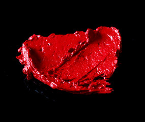 the texture of red lipstick Black background
