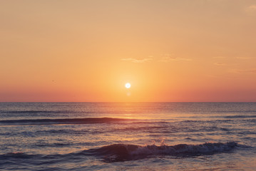 Amazing colorful sunrise at sea, morning beach