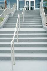 staircase with steel railing in front of office building