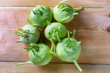 Fresh green kohlrabi on wood background.Kohlrabi (German turnip or turnip cabbage) is a biennial...