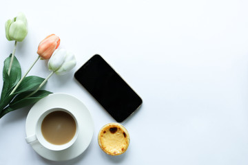tea time and egg tart and donut on white background with smartphone