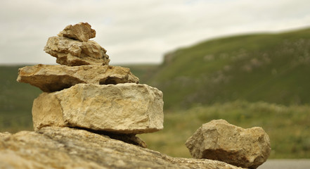 Balanced stones on the alpine meadow near caucasus mountains