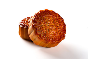 studio shot of two pieces traditional style Chinese mooncakes the Chinese means yolk no logo or trademark