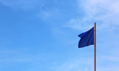 blue flag waves on the blue sky