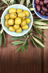 Overhead photo of various olives in bowls with a place for text