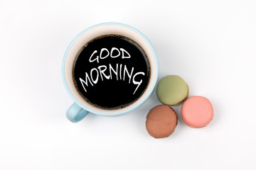 Good Morning. coffee mug and macarons biscuits on a white table