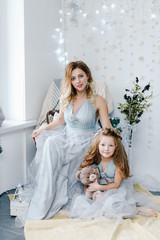 A little daughter will mum at home. Girl holding her mother's hand