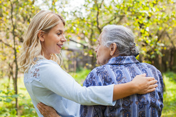 Fototapeta premium Embracing old lady outdoor