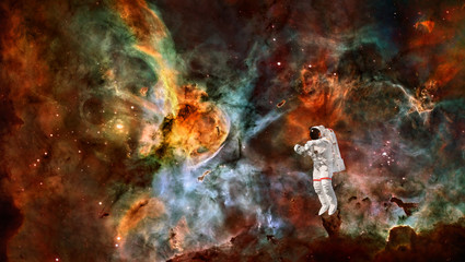 Astronaut in spacesuit in outer space. Spaceman in the universe. Space nebula. Elements of this image furnished by NASA