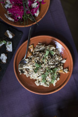 Weird food on a plate on a purple tablecloth