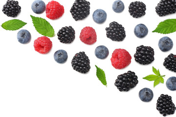 mix of blueberries, blackberries, raspberries and green leaves isolated on white background. top view with copy space