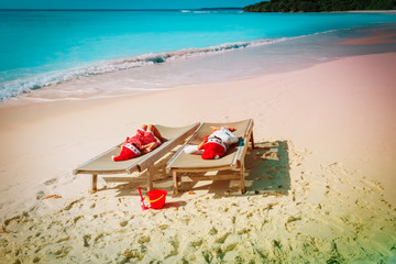 kids-little boy and girl- relax on beach at christmas