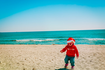 Fototapeta na wymiar cute little girl on winter Christmas beach
