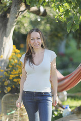 Portrait of a young woman in the garden near the house