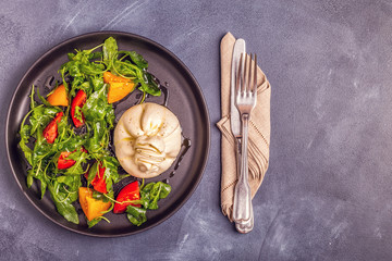 Italian cheese Burrata with fresh arugula, tomatoes, olive oil
