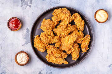 Fried chicken wings with various sauces.