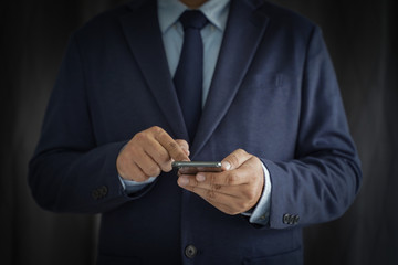 Business man hold the smartphone on the street  and copy space.