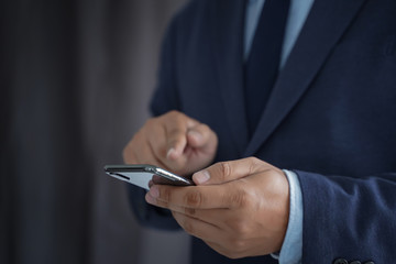 Business man hold the smartphone on the street  and copy space.