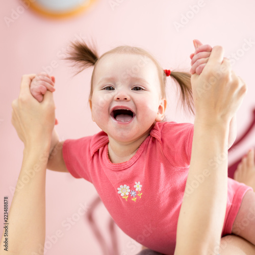 Beautiful Smiling Cute Baby Plays With Mom Stock Photo And Royalty