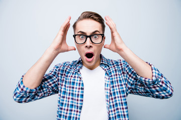 Close up portrait of shocked man in checkered shirt and white t-
