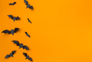 halloween and decoration concept - paper bats flying