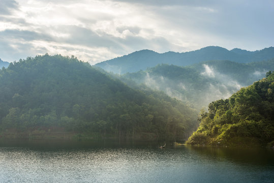 Fototapeta landscape scene of mountain, lake and cloud with people fishing at morning time in tropical asia, Thailand, Phrae