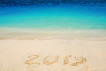 New 2019 year in the South, the sea. Inscription on the sand, celebrate the new year in the tropics. New year holidays