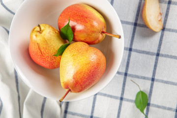 organic pears laying down on a lightly dotted kitchen cloth