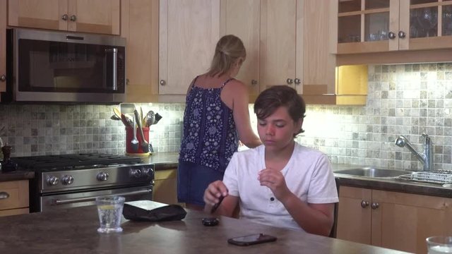 A young diabetic patient, 12 years old, at home testing his blood sugar.