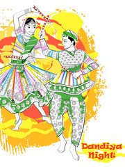Obraz na płótnie Canvas Indian Couple playing Garba in Dandiya Night Navratri Dussehra festival