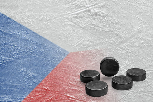 Hockey pucks and the image of the Czech flag on ice