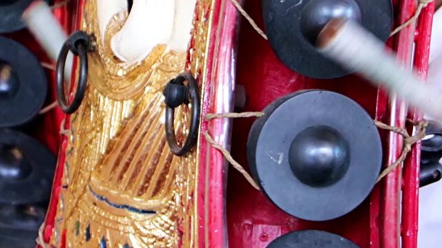 Playing a traditional musical instrument Khong Wong, close up view, Thailand. Musician playing on Kong wong - Thai musical instrument.