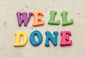 Words Well done written in colorful plastic letters close up shot