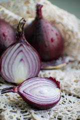 Red onion and red onion slices on wooden cutting board. Red onion.