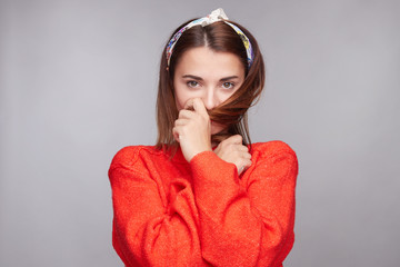 Adorable Caucasian coquette female with dark ginger hair, wears loose red sweater and go rag,...