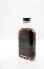 Cold Brew Coffee in glass bottle with black cap isolated on white