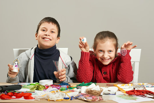 Childrens making decorations for new year holiday. Painting watercolors. Top view. Artwork workplace with creative accessories.