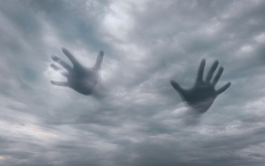 Ghost silhouettes of hands in the sky