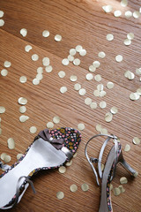 High Heels on Confetti Covered Floor. Party Shoes and Gold Confetti.
