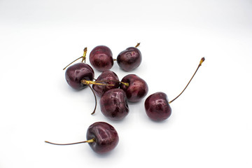 Ripe red fresh cherry on a white isolated background.
