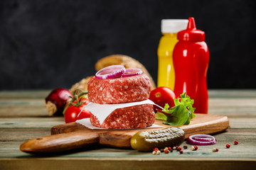 Homemade hamburgers on wooden table